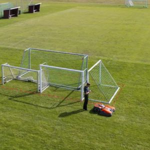 a robot mower stopping in front of football goalposts