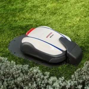 the Honda HRM 2500BC Live Miimo Robot Lawnmower on its charging station