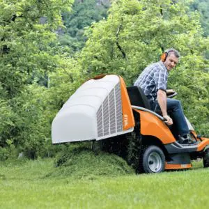 a man emptying the grass collector of an orange ride on mower