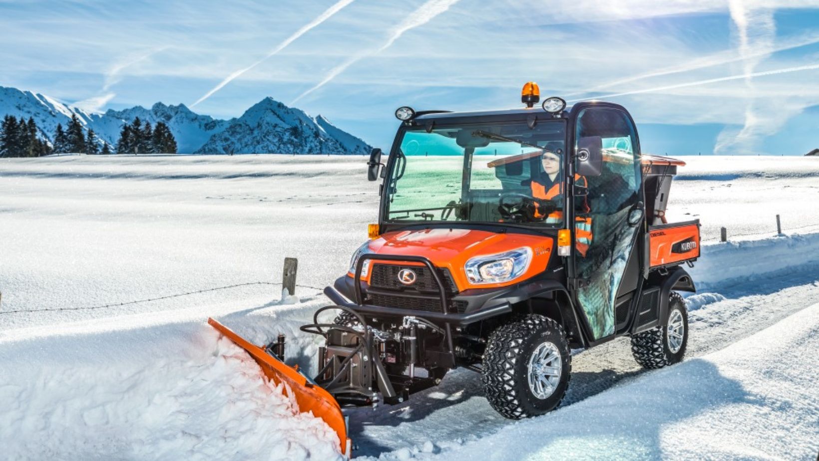 the Kubota RTV-X1110 Utility Vehicle fitted with a snow plough attachment, clearing snow