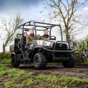 a family riding in a camo Kubota RTV-X1110 Utility Vehicle, on an off-road track