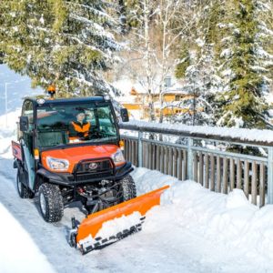 an orange Kubota RTV-X1110 Utility Vehicle ploughing snow from a bridge