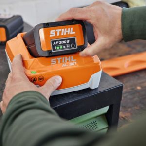 somebody charging a STIHL garden machinery battery