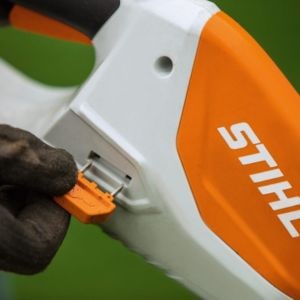 somebody removing the activation key from a STIHL cordless garden tool