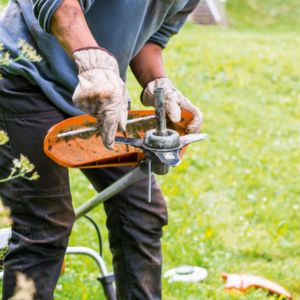 a man servicing a piece of garden machinery