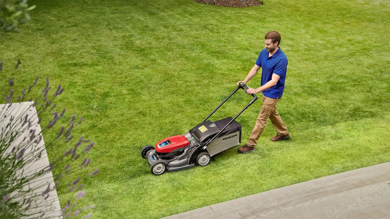 Honda_HRX_Location 04-min a man efficiently mowing a lawn with the correct lawn mower width size