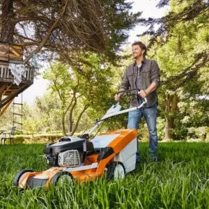 a man mowing a lawn using the STIHL RM 655 Petrol Lawn Mower