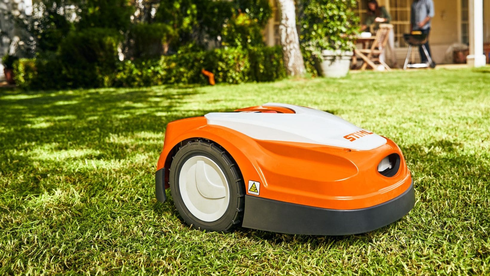 a STIHL iMow Robotic Lawnmower on a lawn in a garden