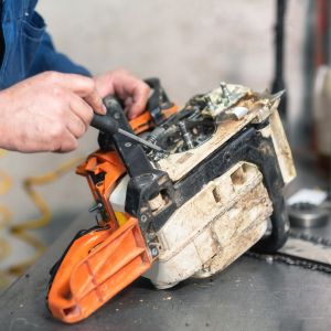 a close-up of someone repairing a chainsaw