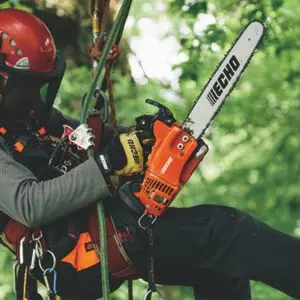someone in a tree canopy, supported by a safety harness, holding an ECHO top handled chainsaw
