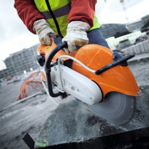 someone using the STIHL TS 410 Petrol Cut-off Machine to cut concrete on a building site
