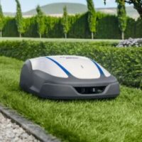 a Honda Miimo 4000 Live Robotic Mower travelling along a narrow stretch of lawn