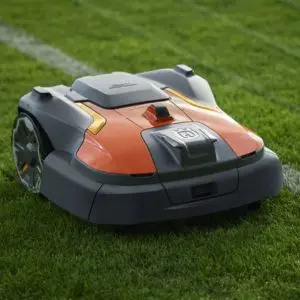 a close up of the Husqvarna Automower® 580 EPOS® Robotic Mower on a sports pitch