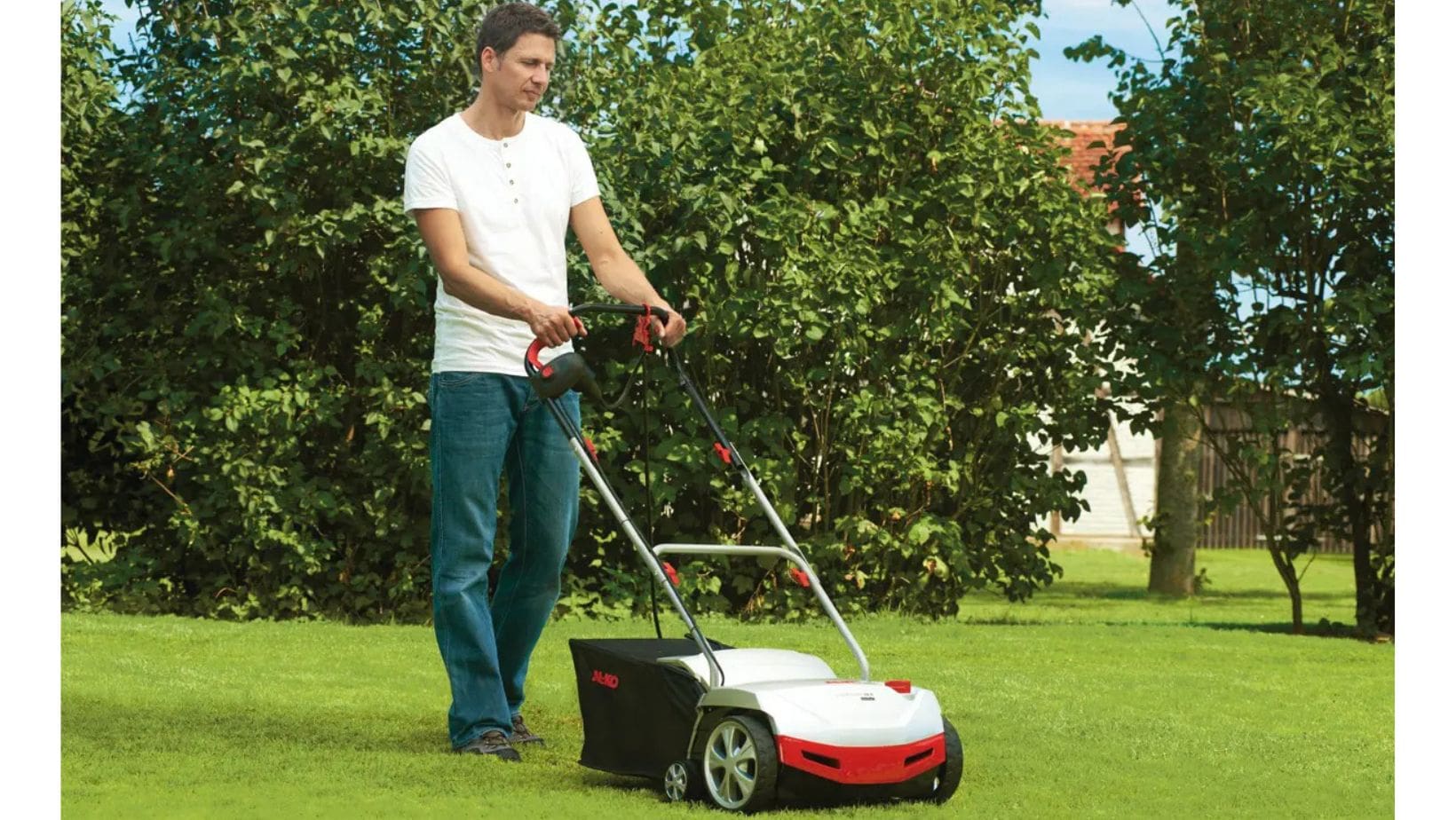 a man scarifying a lawn using an AL-KO 38 E Electric Scarifier