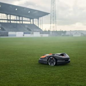 a Husqvarna Automower® 580 EPOS® Robotic Mower on the pitch at a football ground
