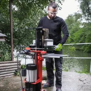 a man wearing safety glasses, operating the AL-KO Easy LSV 5506 Electric Log Splitter