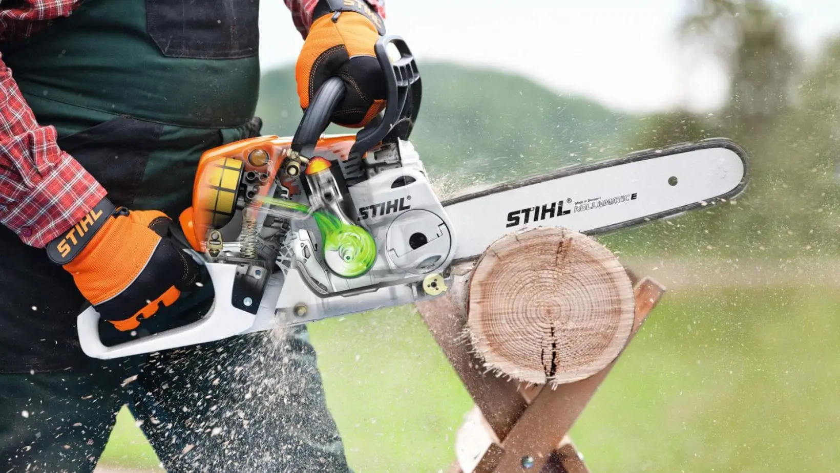someone using the STIHL MS 231 Petrol Chainsaw to cut a log, which is positioned on a wooden sawhorse