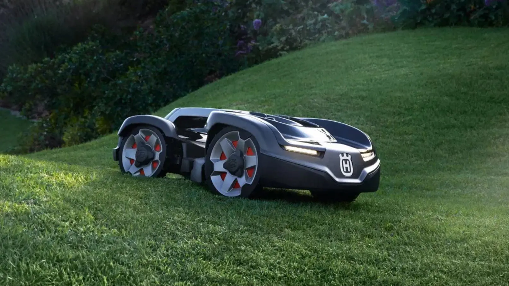 a Husqvarna Automower® Aspire™ R4 Robotic Lawnmower travelling across an undulating lawn