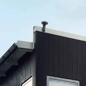 the Husqvarna EPOS® RS1 Reference Station on top of a black-clad building with white trim