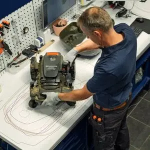 a Husqvarna technician servicing an Automower