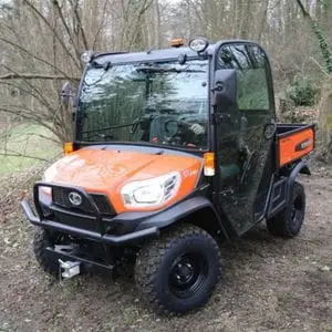 the Kubota RTV-X1110 Utility Vehicle parked in a clearing in a wood