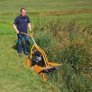 a man cutting down scrub using the AS MOTOR AS 62 4T Brushcutter Mower