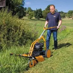 a man using the AS MOTOR AS 62 4T Brushcutter Mower to cut down very long grass and scrub