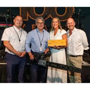 4 people at the STIHL 100 Awards ceremony, including Ron Smith & Co's Managing Director Mark Smith, who is receiving a STIHL MS 500i Centennial Edition Chainsaw and the STIHL 100 Year Award from STIHL GB Managing Director Kay Green 