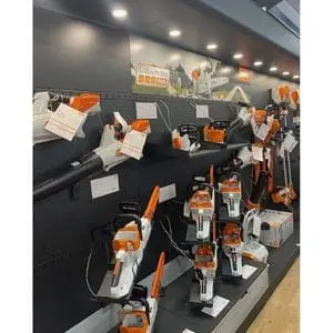STIHL leaf blowers and chainsaws on display shelves inside a Ron Smith & Co showroom