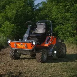 the Stella Racoon 110 Ride-on Flail Mower parked in a clearing in a wood