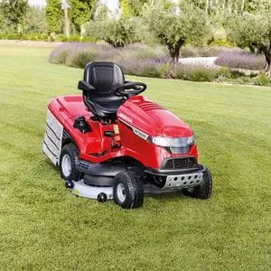 the Honda HF 2625 HTE Premium Petrol Lawn Tractor parked on a large lawn