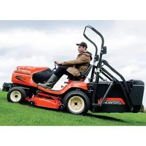 a man wearing a baseball cap, cutting grass on a slight incline using the Kubota G21E HD Ride-On Mower