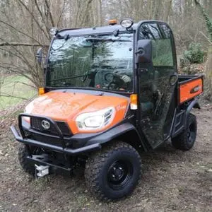 the Kubota RTV-X1110 Utility Vehicle parked in a clearing in a wood