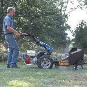 a man cutting grass using the BCS 706 PowerSafe®2 Wheel Tractor equipped with a single blade mower