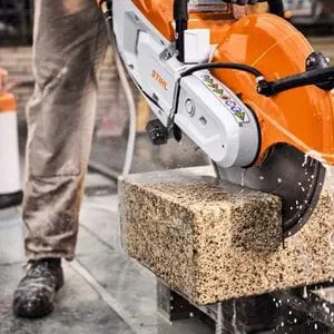 a close up of someone cutting through a stone block using the STIHL TSA 500 Cordless Cut-off Machine
