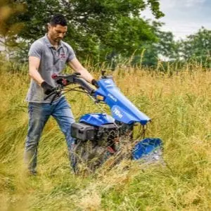 a man mowing long grass with the BCS 780HY PowerSafe® Hydrostatic Petrol Two Wheel Tractor